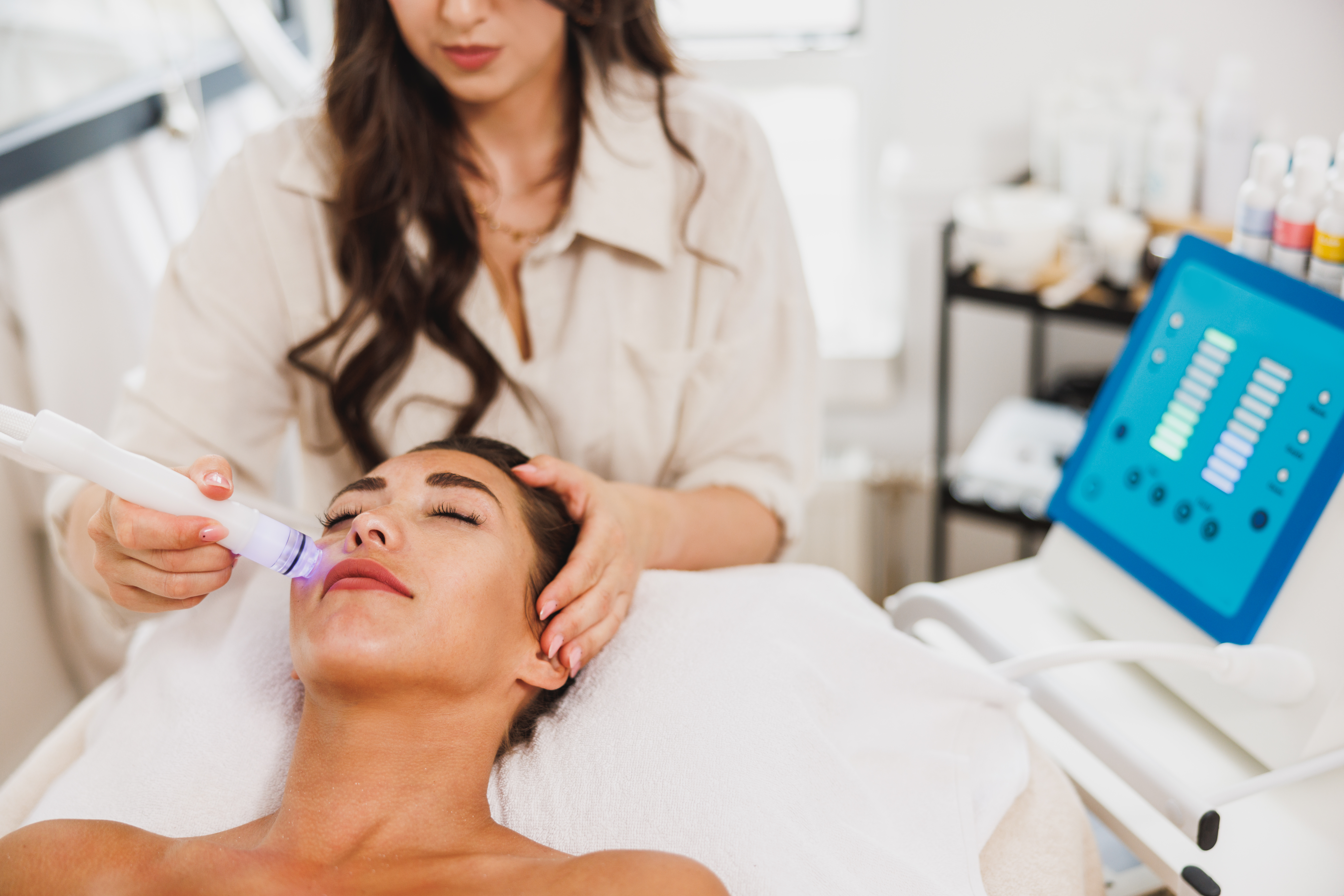 Beautiful young woman enjoying a hydrafacial treatment at the beauty salon.